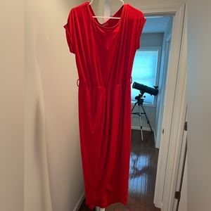 New dress. Front has a slit as design. Belt and tags still on. Size large.